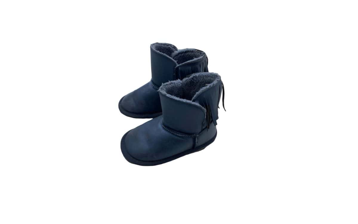 A pair of blue baby boots with a faux fur trim and tassels. The boots appear to be made of a soft, leather-like material and have a warm, cozy lining.