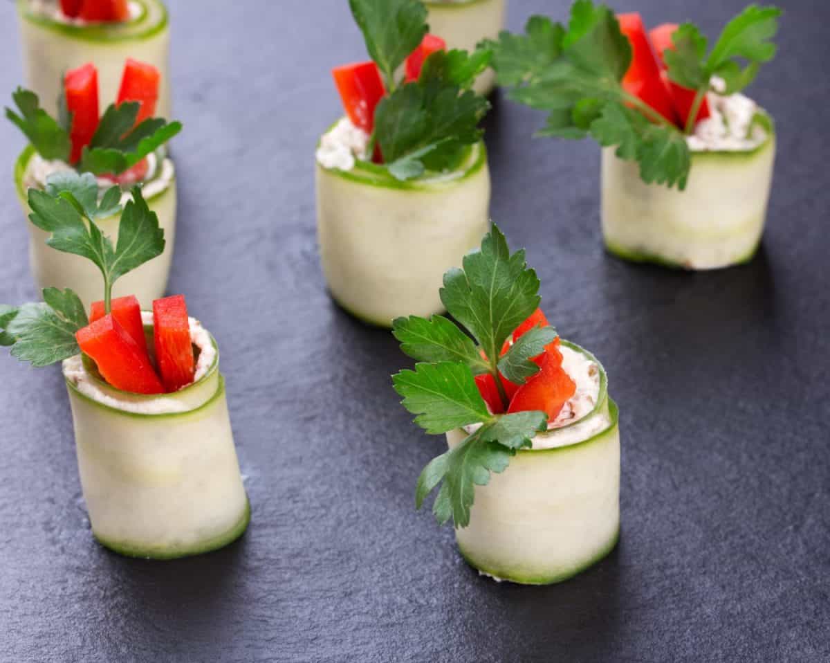 Cucumber rolls on black slate plate