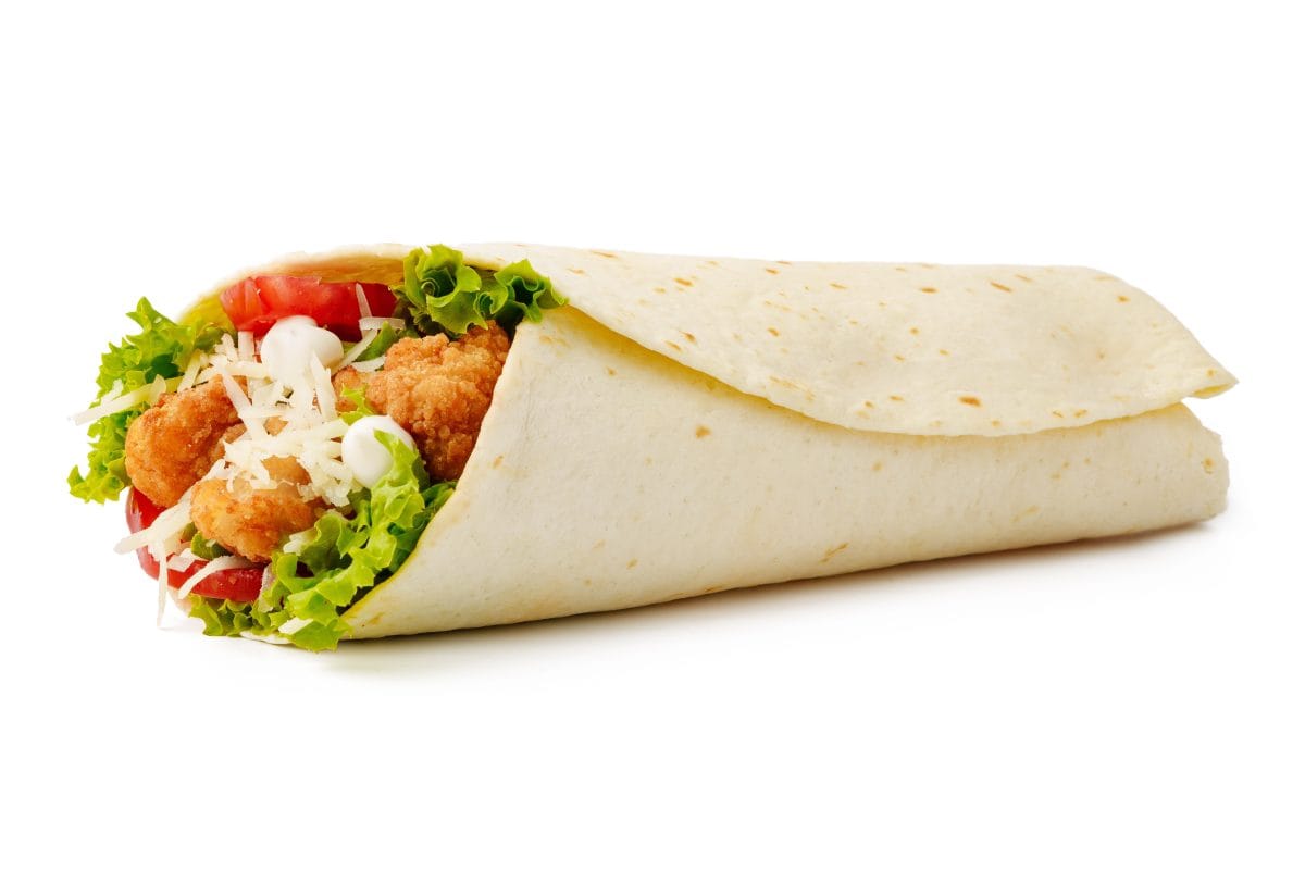 Tortilla wrap with fried chicken meat and vegetables isolated on white background, close up