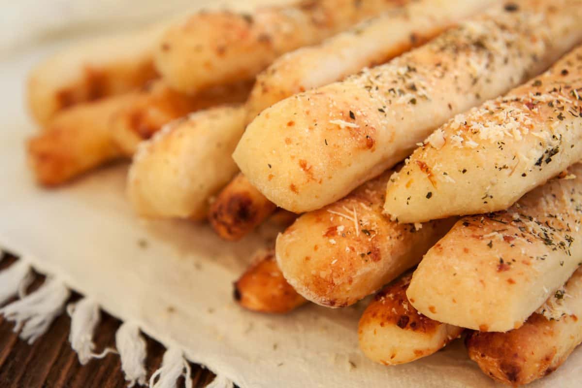 Homemade cheese bread sticks grissini on a dark wooden background