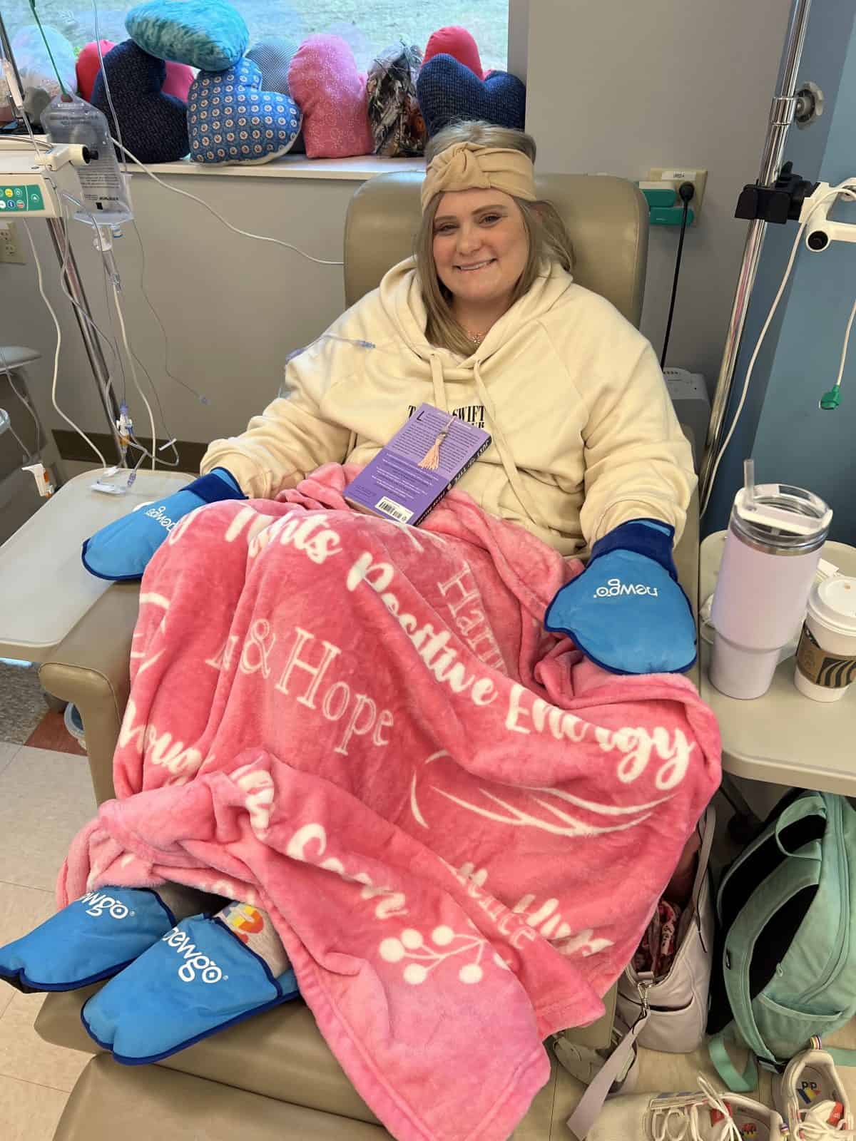 Sydni Ellis with ice packs on her hands and feet during chemo.