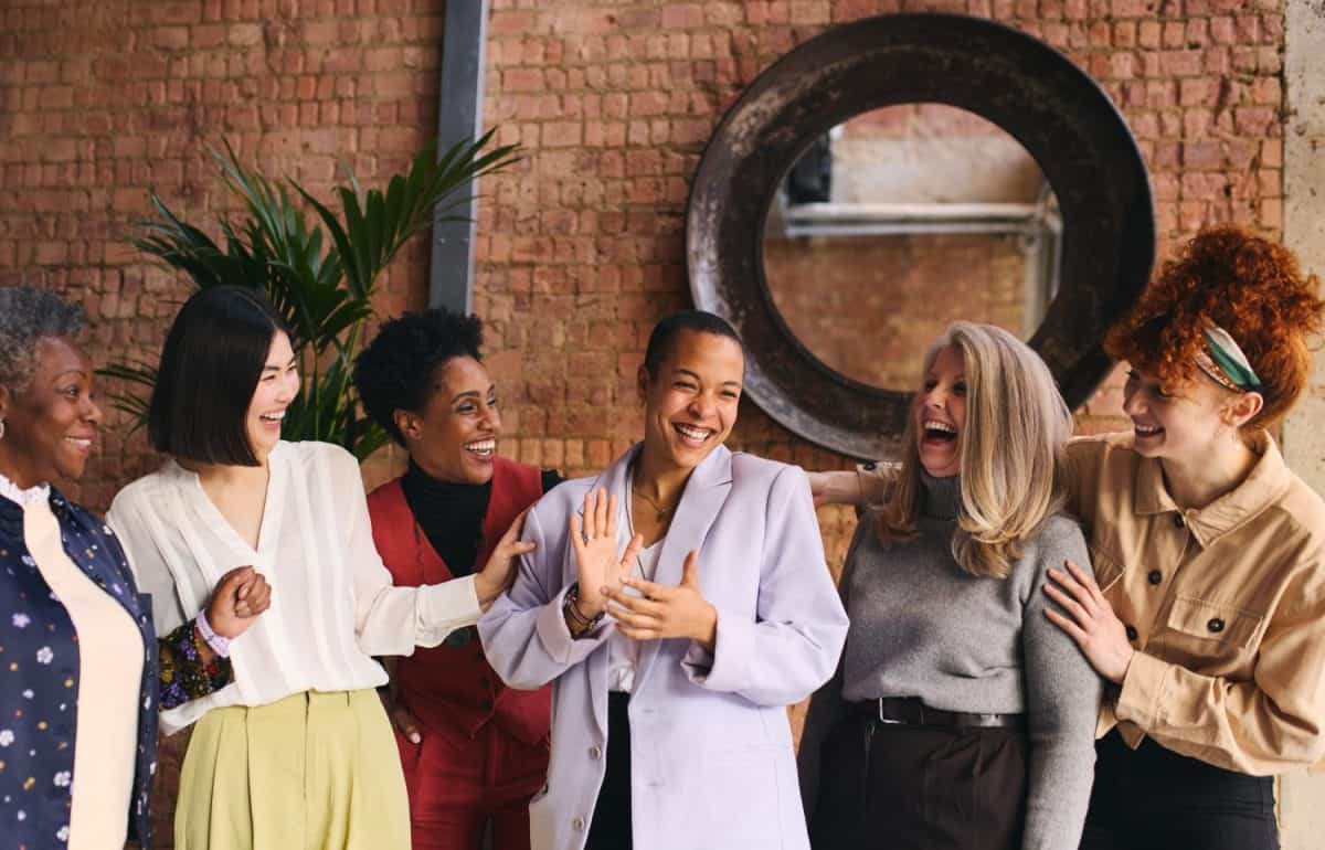 International Women's Day portrait of cheerful multiethnic mixed age range businesswomen celebrating, Embrace Equity